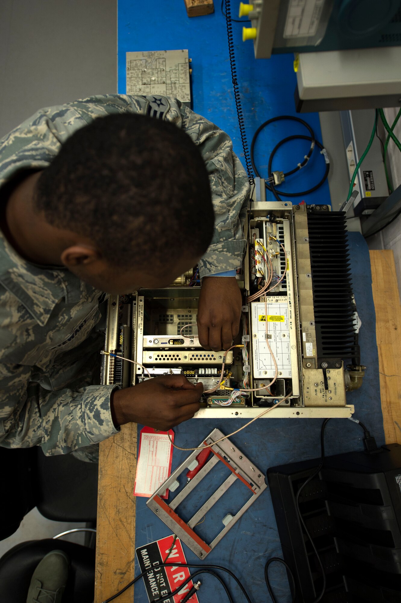 U.S. Air Force Senior Airman Jaquan Stewart, 606th Air Control Squadron radio frequency transmission technician from Folkston, Ga., disassembles a GRC-171 radio transceiver at Spangdahlem Air Base, Germany, June 30, 2014. While inspecting the equipment, Airmen clear out any dust and debris, and search for any abnormalities that would endanger the equipment or operators. (U.S. Air Force photo by Senior Airman Gustavo Castillo/Released)