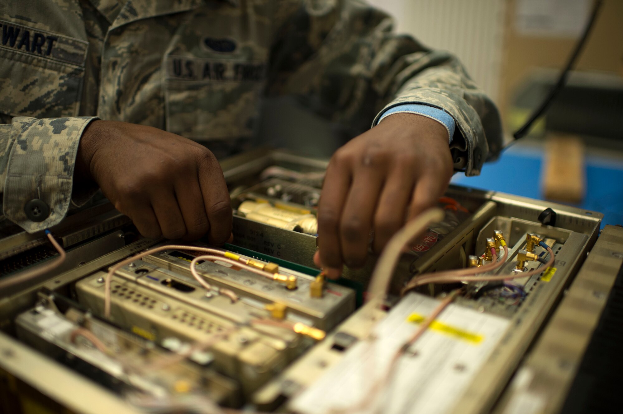 U.S. Air Force Senior Airman Jaquan Stewart, 606th Air Control Squadron radio frequency transmission technician from Folkston, Ga., performs maintenance on a GRC-171 radio transceiver at Spangdahlem Air Base, Germany, June 30, 2014. Airmen must inspect equipment on a regular basis in order to maintain a deployable and mission-ready status to support real-world operations. (U.S. Air Force photo by Senior Airman Gustavo Castillo/Released)