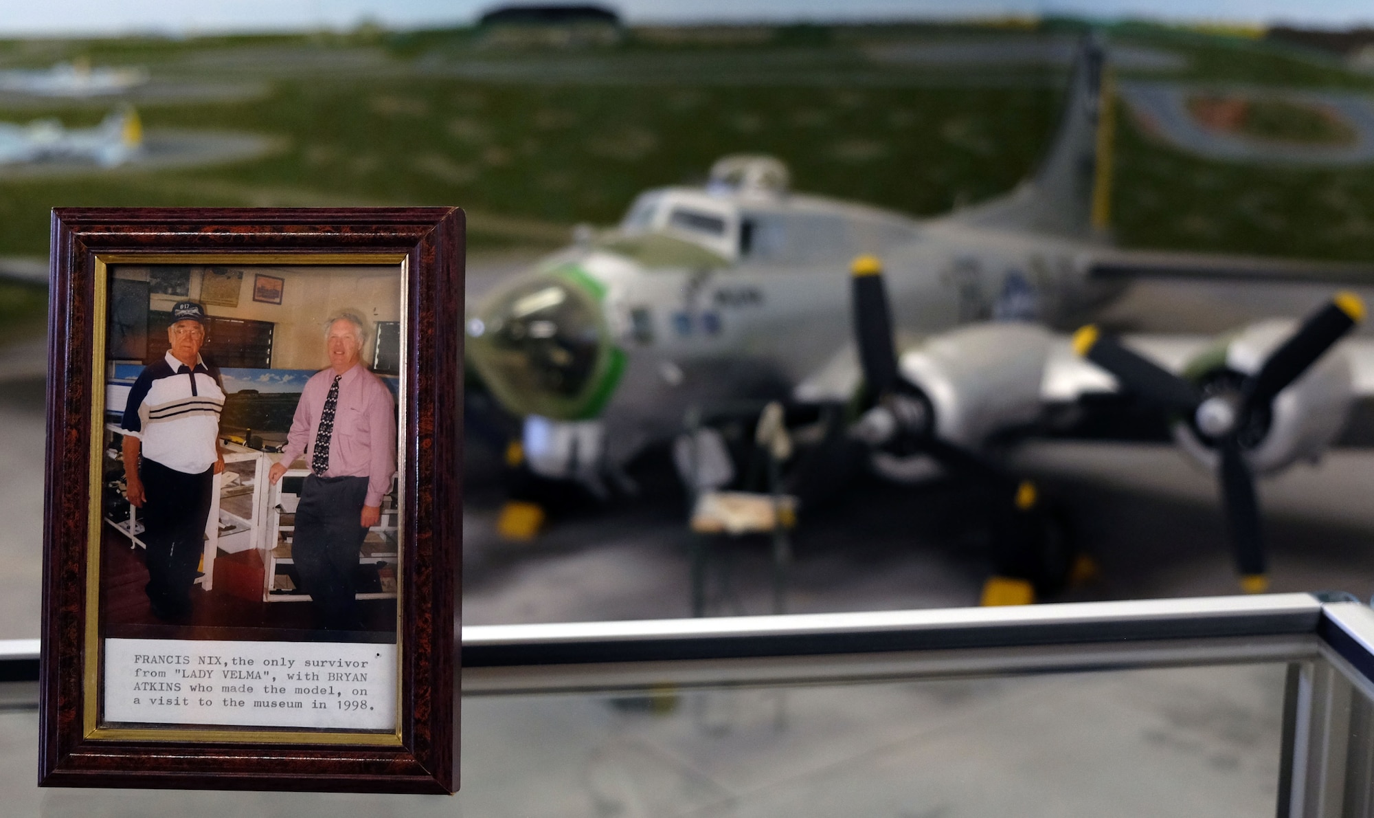 The Parham Airfield Museum commemorates a visit from Francis Nix, a World War II veteran, next to a model of Lady Velma, the B-17 Flying Fortress he used to fly in June 28, 2014, in Suffolk, England. The model was donated to the museum in 1998 in honor of Nix, who was the sole survivor of a collision between the Lady Velma and another B-17. (Courtesy photo/Dee Webb)