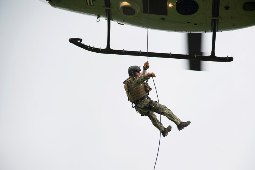 U.S Navy Explosive Ordnance Disposal Technician Senior Chief Mark Morgan assigned to EOD Mobile Unit 5, Yokosuka, Japan, rappels out of a UH-1N Huey June 25, 2014 at Yokota Air Base, Japan.  The Navy EOD team and the 459th Airlift Squadron worked  together to allow the pilots and the flight engineers to test their ability to keep the aircraft as level as possible so that  to provide a stable platform for the rappellers.  (U.S. Air Force photo by Tech Sgt. Melissa K. Mekpongsatorn/Released)
