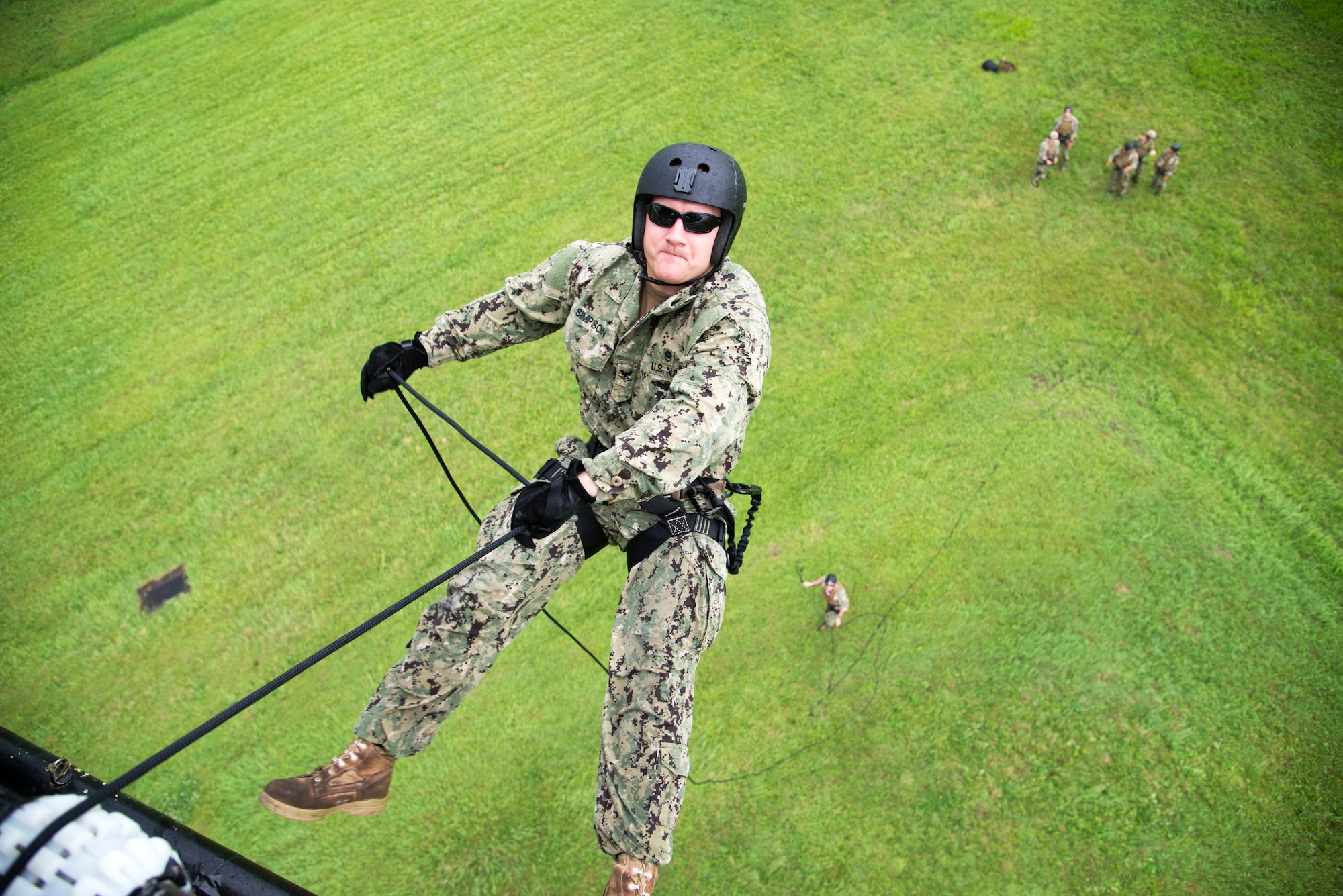 U.S. Navy Diver 2nd Class Jeremy Simpson assigned to the ship repair facility at Yokosuka Naval Base, Japan rappels out of a UH-1N Huey June 25, 2014 at Yokota Air Base, Japan.  The Navy EOD team practiced rappelling techniques while the 459th Airlift Squadron pilots and flight engineers had the opportunity to hone their abilities. (U.S. Air Force photo by Tech Sgt. Melissa K. Mekpongsatorn/Released)