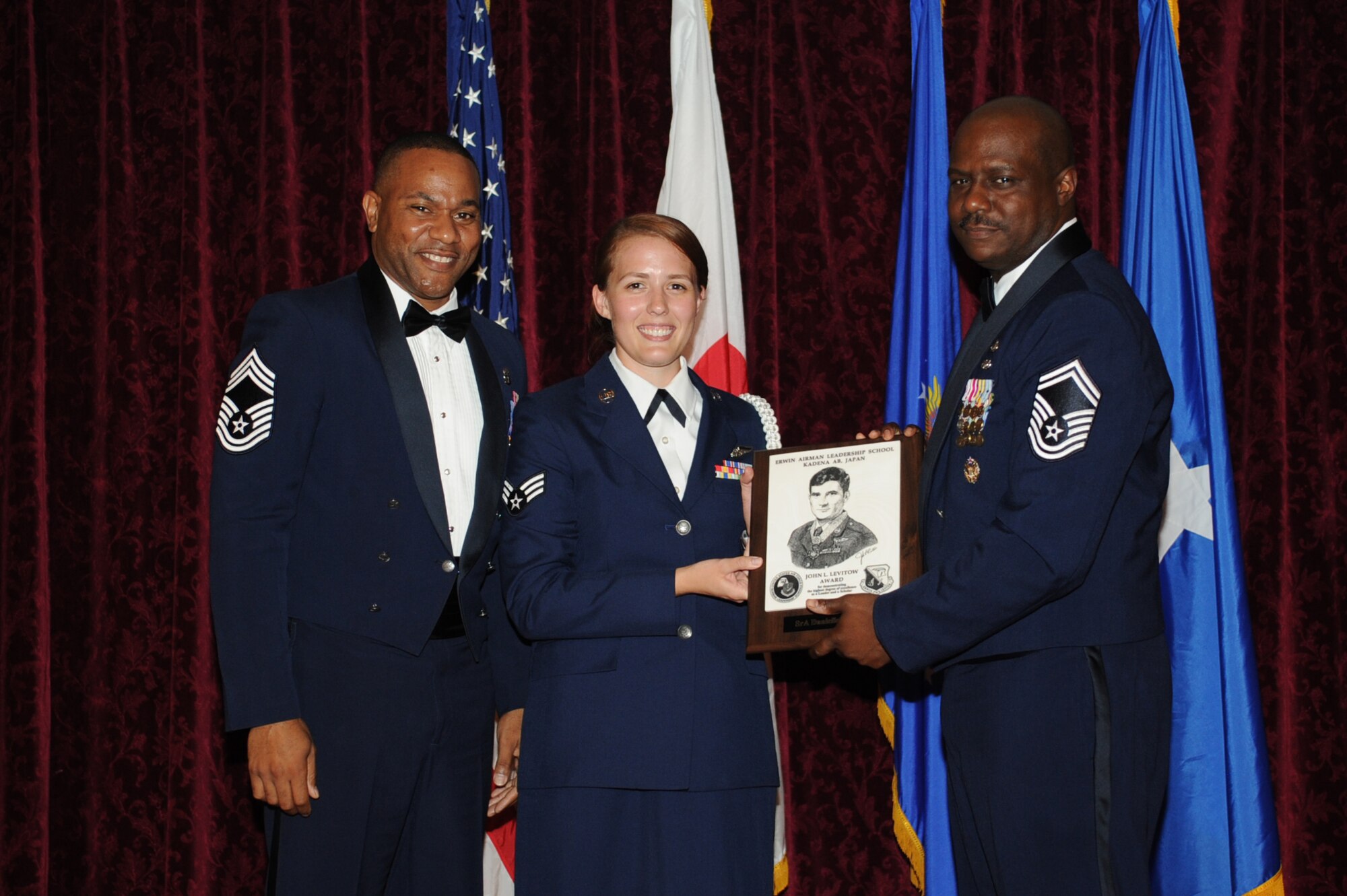 U.S. Air Force Senior Airman Danielle N. Pfarr, 961st Airborne Air Control Squadron accepts the John L. Levitow Award during the graduation ceremony for ALS Class 14-E on Kadena Air Base, Japan, May 30, 2014. The John L. Levitow Award is presented to the student who earns the highest average score on evaluations and most embodies the Air Force core values. (U.S. Air Force photo by Airman 1st Class Zackary A. Henry)