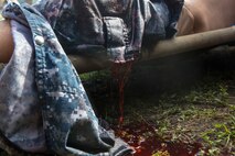 Fake blood pours from a wound as an actor from 2nd Medical Battalion, 2nd Marine Logistics Group lies on a stretcher during the battalion’s mass casualty training scenario at Camp Lejeune, N.C., June 28, 2014. Corpsmen carried the actor inside a tent, where members of the unit’s Forward Resuscitative Surgical System team cared for the simulated patient.