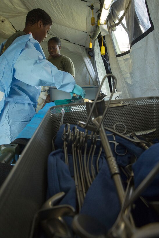 Petty Officer 2nd Class Keyetta Cross (left) and Petty Officer 2nd Class Kwyanetta Pritchett prepare to treat simulated patients as part of a Forward Resuscitative Surgical System team with 2nd Medical Battalion, 2nd Marine Logistics Group at Camp Lejeune, N.C., June 28, 2014. Cross and Pritchett aided physicians by preparing and handing over the necessary tools for operations.