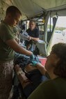 Seaman Anthony Wells (left), a corpsman with 2nd Medical Battalion, 2nd Marine Logistics Group, listens as Lt. Gail Murray, a critical care nurse with the unit, explains how to use the ultrasound machine during pre-deployment training at Camp Lejeune, N.C., June 28, 2014. The battalion used the training to prepare its Forward Resuscitative Surgical System team for an upcoming deployment.