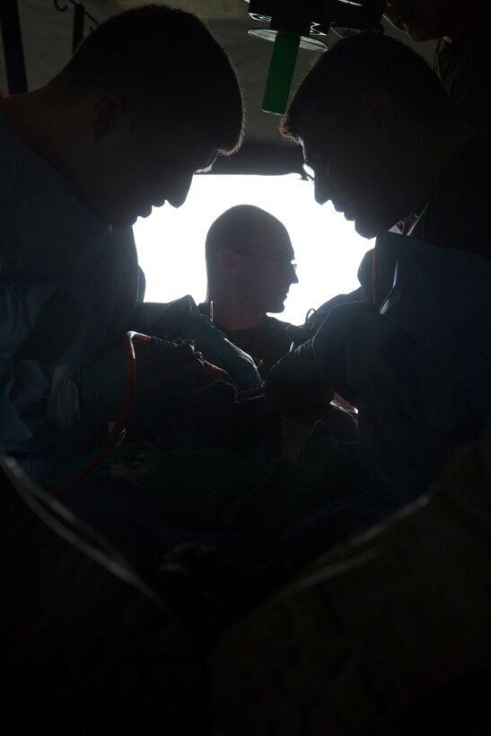 Members of a Forward Resuscitative Surgical System team with 2nd Medical Battalion, 2nd Marine Logistics Group, operate on a fake patient wearing a CutSuit, a hyper-realistic surgical simulator, during pre-deployment training at Camp Lejeune, N.C., June 28, 2014. The CutSuits allowed the team to treat traumatic injuries in a realistic training environment.