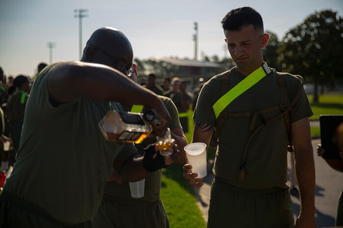 A Marine with Supply Company, 2nd Supply Battalion, 2nd Marine Logistics Group waits for a serving of whiskey during a physical and alcohol awareness training session aboard Camp Lejeune, N.C., June 30, 2014. The intent of the training was to build attentiveness to how alcohol can impair basic motor skills and coordination.