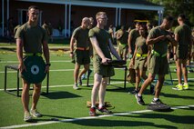 Marines with Supply Company, 2nd Supply Battalion, 2nd Marine Logistics Group prepare for a workout exercise during a unit alcohol awareness and physical training session aboard Camp Lejeune, N.C., June 30, 2014. The unit incorporated physical training into its pre-holiday safety brief to keep the Marines engaged and alert.