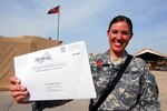 A Soldier holds up her absentee ballot before the 2008 presidential election. "Even though we are overseas, I wanted to make sure our voices are heard," said Army Spc. Andrea Boyd, whom at the time was an aviation supply specialist of Task Force 34, B Company, 834th Aviation Support Battalion in Joint Base Balad, Iraq.
