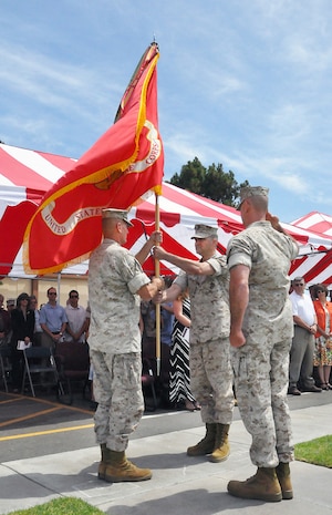 Col. Chris Snyder (left) passes the flag to Col. Ben Stinson during the Marine Corps Tactical Systems Support Activity change of command ceremony June 26 at Camp Pendleton, Calif. Stinson previously served as project manager for Robotic Systems Joint Program Office in Warren, Mich. He will now serve as the 21st commanding officer for MCTSSA, a subordinate activity to Marine Corps Systems Command.