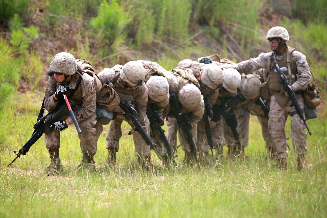 Private First Class Jeffrey Williams (Far left), 18, a combat engineer with Engineer Company, Marine Wing Support Squadron 273, Marine Aircraft Group 31, and native of Bellefonte, Pa., prepares to breach a building during a field exercise aboard Army base, Ft. Stewart, Ga., June 24. Combat Engineers build, repair and maintain buildings, roads and power supplies while employing explosives for construction and demolition projects. MWSS-273 provides all essential aviation ground support to a designated fixed-wing component of a Marine Aviation Combat Element to include internal airfield communications, weather services, expeditionary airfield services, aircraft rescue and firefighting, aircraft and ground refueling, essential engineering services, motor transport, messing, chemical defense, security and law enforcement, airbase commandant functions, and explosive ordinance disposal.