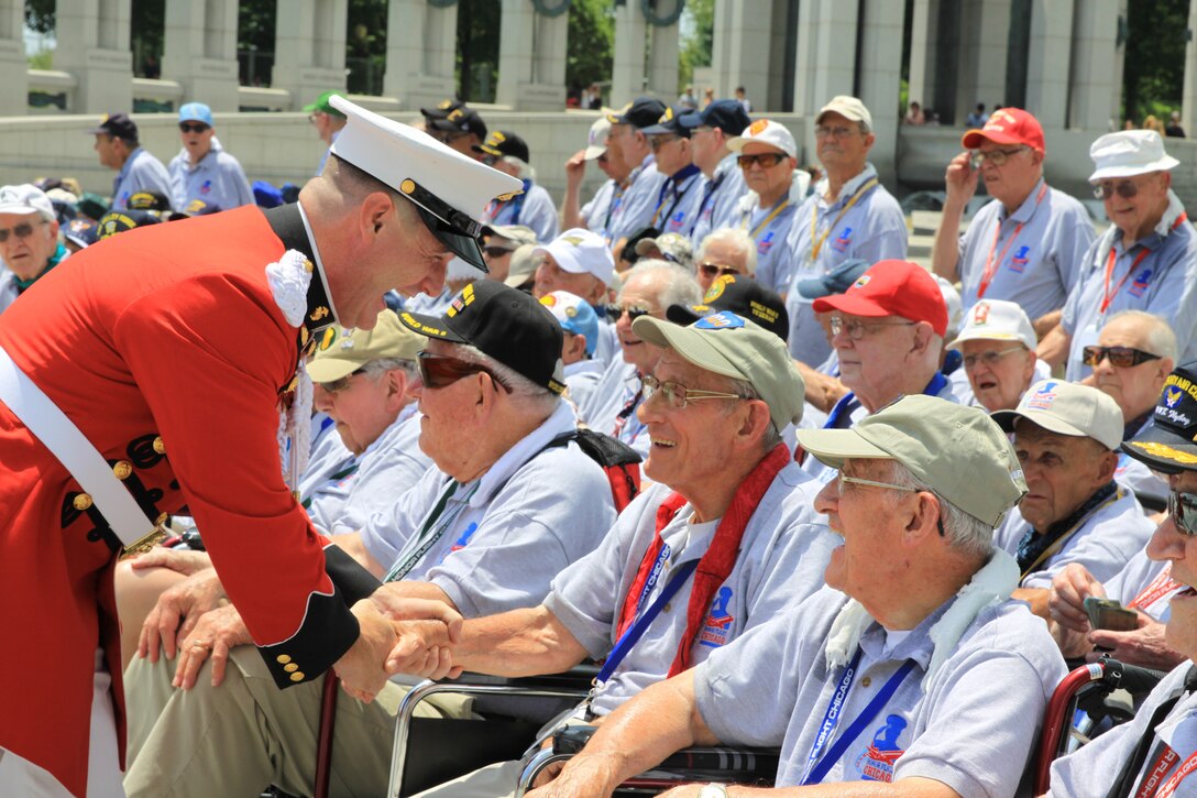 On July 2, 2014, baritone vocalist Master Sgt. Kevin Bennear and trumpet player Staff Sgt. Amy McCabe performed for an Honor Flight from Chicago at the World War II Memorial in Washington, D.C. (U.S. Marine Corps photo by Master Sgt. Kristin duBois/released)