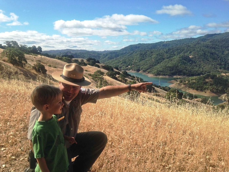 USACE Park Ranger Joel Miller points out a landmark to his son Hudson while hiking along the North Slope Trail at Lake Sonoma June 26, 2014. The North Slope Trail at Lake Sonoma was designated a national recreation trail by the U.S. Department of the Interior. 