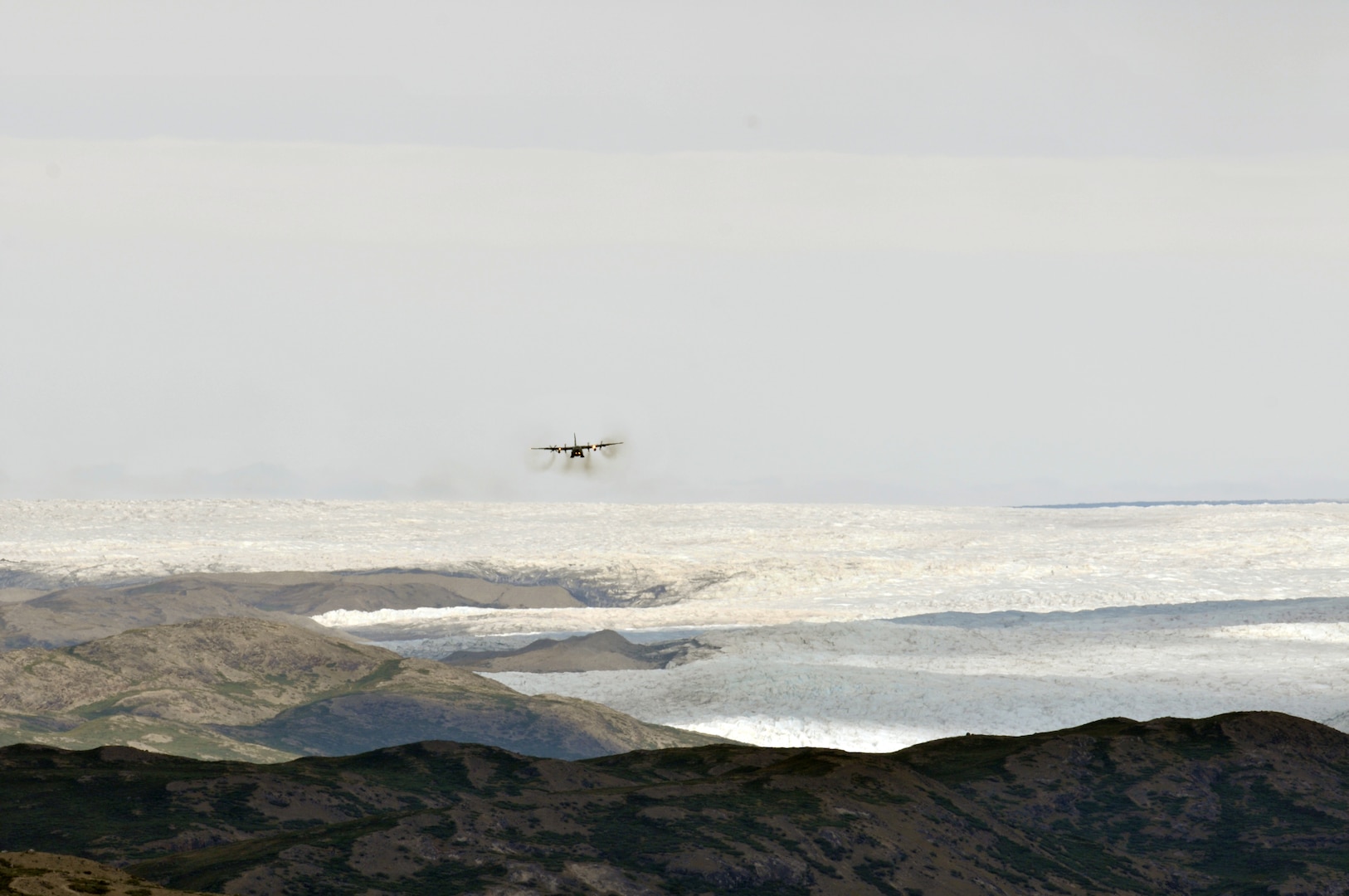 An LC-130 "Skibird" with the 109th Airlift Wing from Stratton Air National Guard Base, Scotia, N.Y., returns to Kangerlussuaq, Greenland, on June 29, 2014, from a mission at Summit Camp. Two LC-130s and 70 Airmen from the Wing recently completed the fourth rotation of the 2014 Greenland season. The unit flies supply and refueling missions to various camps in support of the National Science Foundation and also trains for the Operation Deep Freeze mission in Antarctica.
