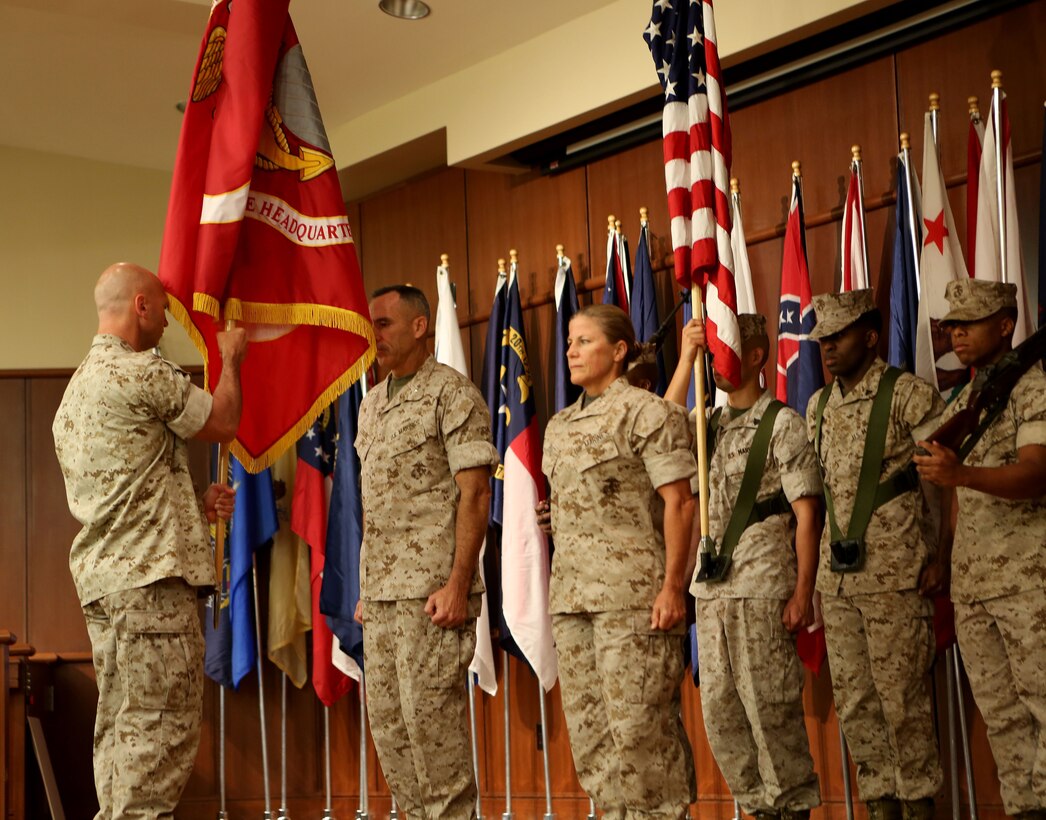 Sgt. Maj. Michael E. Sprague of Force Headquarters Group, Marine Forces Reserve, passes the colors to Brig. Gen. Paul K. Lebidine who relinquished command to Col. Helen G. Pratt, July 2, 2014. Before taking command, Pratt served as the Deputy Commander for 4th MLG.