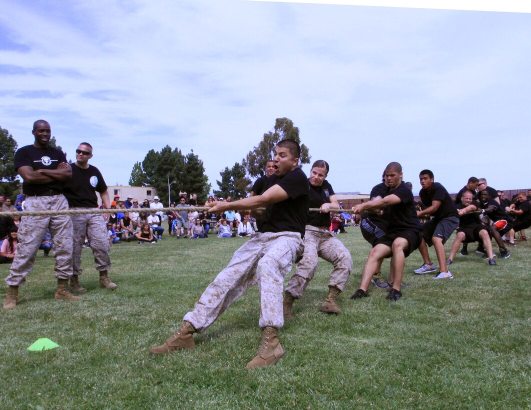 Recruiting Station San Francisco Marines and poolees participate in a tug-of-war during the RS' Poolee Family Day aboard Moffett Airfield, May 17, 2014. The Poolee Family Day brought together over 300 poolees and their families, to strengthen the relationships between them and Marines. The poolees participated in a cadence run, field competitions, and were introduced to a few drill instructors throughout the course of the day.