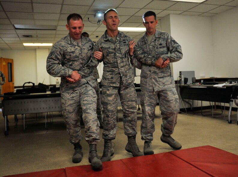 Capt. Tate Grogan, 51st Security Forces Squadron assistant operations officer, gets shocked by a Taser during training on Osan Air Base, Republic of Korea, June 27, 2014. When struck by a Taser a person can experience stimulation of his or her sensory nerves and motor nerves, resulting in strong involuntary muscle contractions. (U.S. Air Force photo/Senior Airman David Owsianka)