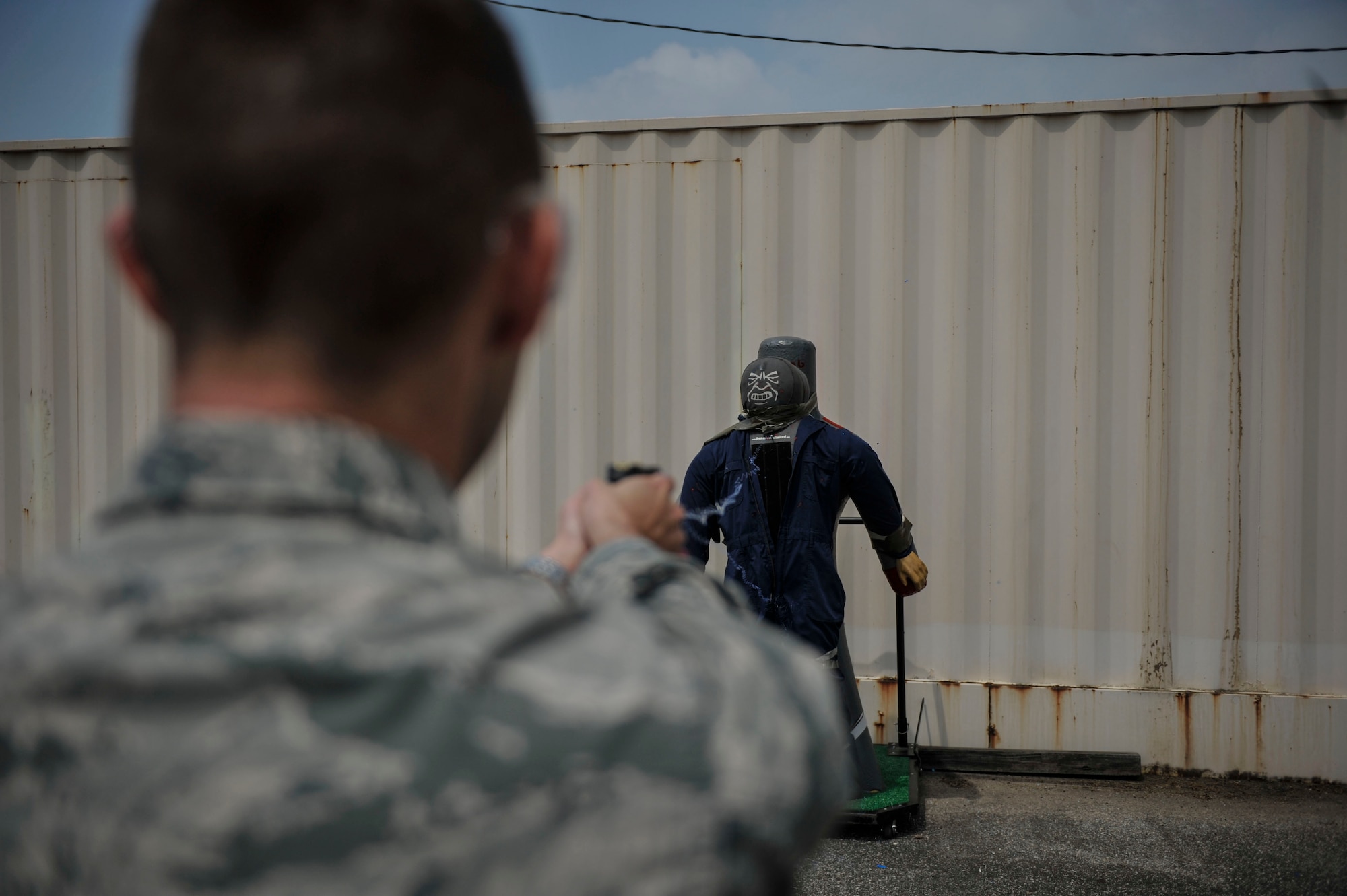 Capt. Tate Grogan, 51st Security Forces Squadron assistant operations officer, shoots a dummy during Taser training on Osan Air Base, Republic of Korea, June 27, 2014. The weapon uses electrical current to disrupt voluntary control of muscles causing neuromuscular incapacitation. (U.S. Air Force photo/Senior Airman David Owsianka)