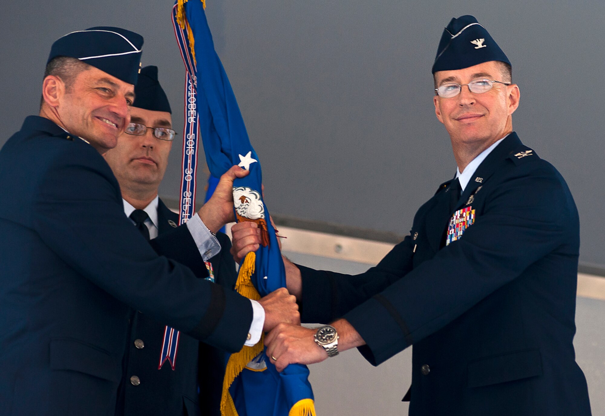 Air Force Col. Brian Bruckbauer receives command of the 673d Air Base Wing and Joint Base Elmendorf-Richardson from Air Force Lt. Gen. Russell Handy during a change of command ceremony at JBER, Alaska, July 2, 2014. Bruckbauer was previously assigned to the Office of the Secretary of Defense at the Pentagon as the Military Assistant to the Under Secretary of Defense for Policy. Handy is the commander of the 11th Air Force. (U.S. Air Force photo/Staff Sgt. Robert Barnett)