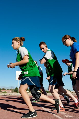Airmen begin the 1.5 mile run portion of the required annual physical fitness test at the Warrior Fitness Center, June 27, 2014, Nellis Air Force Base, Nev. Developing good habits, such as exercising routinely while in the Air Force, not only improves PFT scores, but also encourages Airmen to maintain their physical well-being after their service has ended. (U.S. Air Force photo by Airman 1st Class Thomas Spangler)