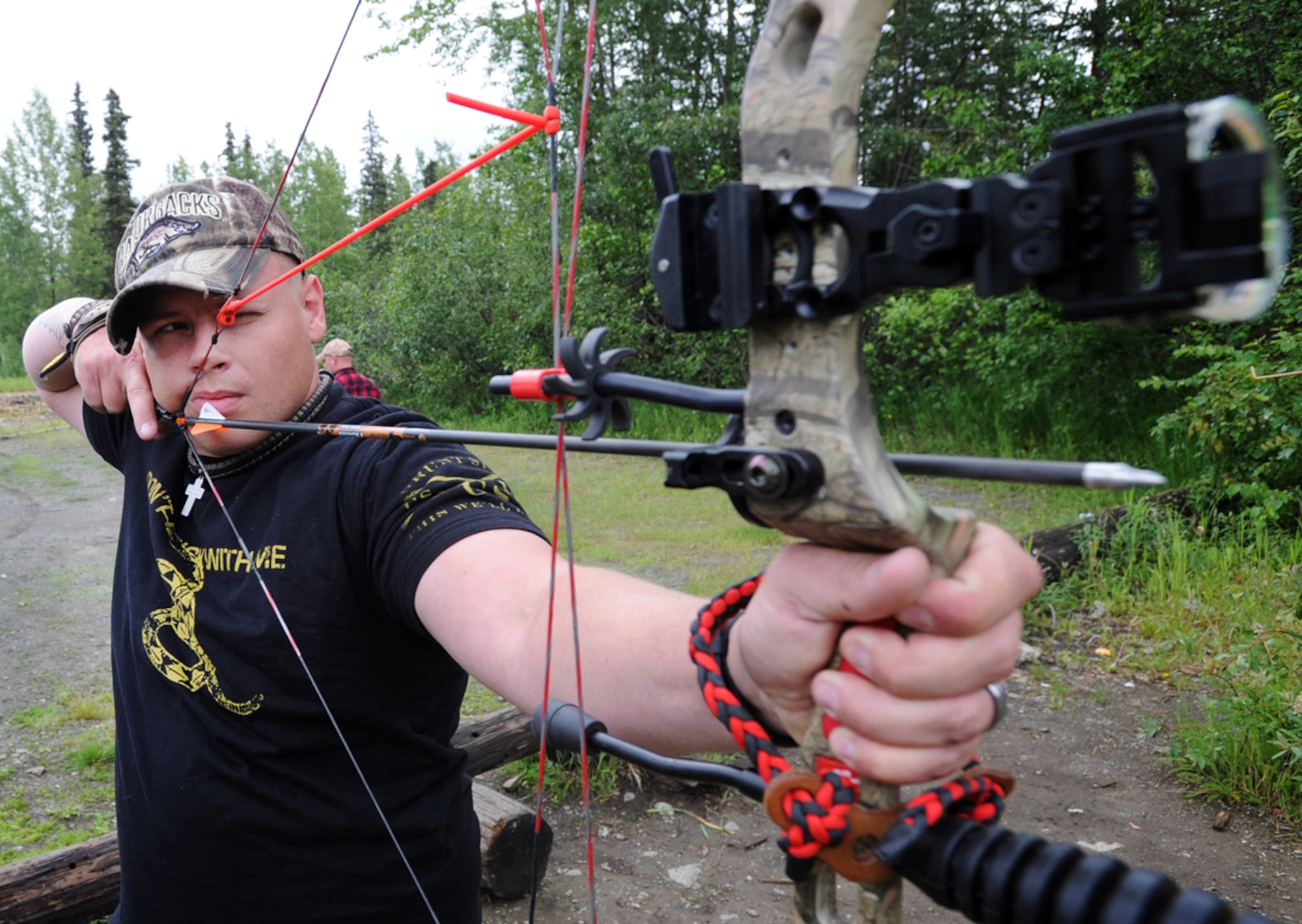 Specialist James Nichoalds, assigned to the 109th Transportation Company, a native of Vilonia, Ark., aims at a target on the base archery range during the 19th annual Military Appreciation Picnic and Arctic Warrior Olympics on Joint Base Elmendorf-Richardson, Friday, June 27, 2014. (U.S. Air Force photo/Justin Connaher) 