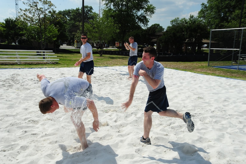 Airmen enjoy their new volleyball court built for dorm residents at Joint Base Andrews, Md., during a friendly game of volleyball and water balloon tag, June 26, 2014. (U.S. Air Force photo/Airman 1st Class Joshua R. M. Dewberry)