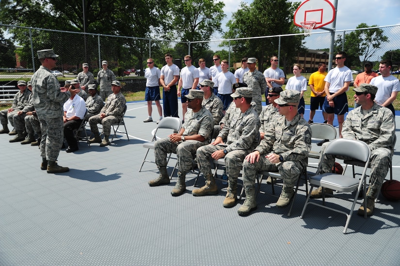 Col. Bill Knight, 11th Wing/Joint Base Andrews commander, speaks to Airmen, Sailors and base leadership gathered for a ribbon cutting ceremony officially opening the new volleyball and basketball courts built for dorm residents at Joint Base Andrews, Md., June 26, 2014. (U.S. Air Force photo/Airman 1st Class Joshua R. M. Dewberry)