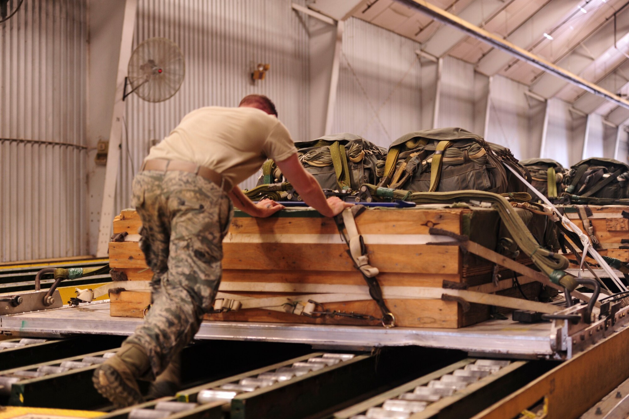 Senior Airman Mitchell Sellers, a 19th Logistics Readiness Squadron aerial delivery journeyman, pushes a heavy equipment platform June 27, 2014, at Little Rock Air Force Base, Ark. When full, the pallets weigh more than 2,700 pounds. (U.S. Air Force photo by Senior Airman Kaylee Clark)