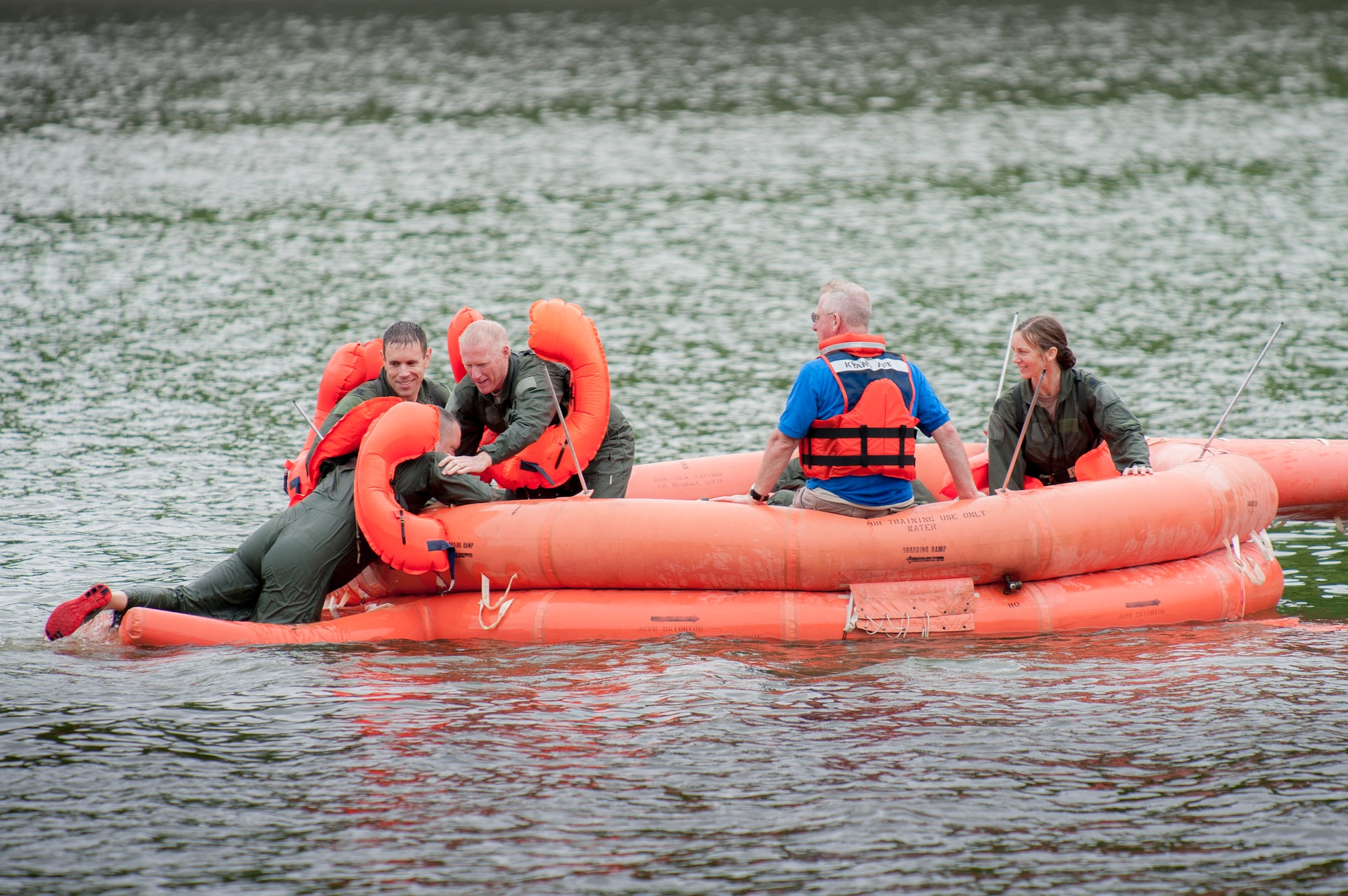 Members of the Kentucky Air National Guard’s 165th Airlift Squadron conduct water survival training in a 20-person life raft at Taylorsville Lake in Taylorsville, Ky., June 5, 2014. The day’s training also covered land survival techniques and orienteering. (U.S. Air National Guard photo by Maj. Dale Greer)