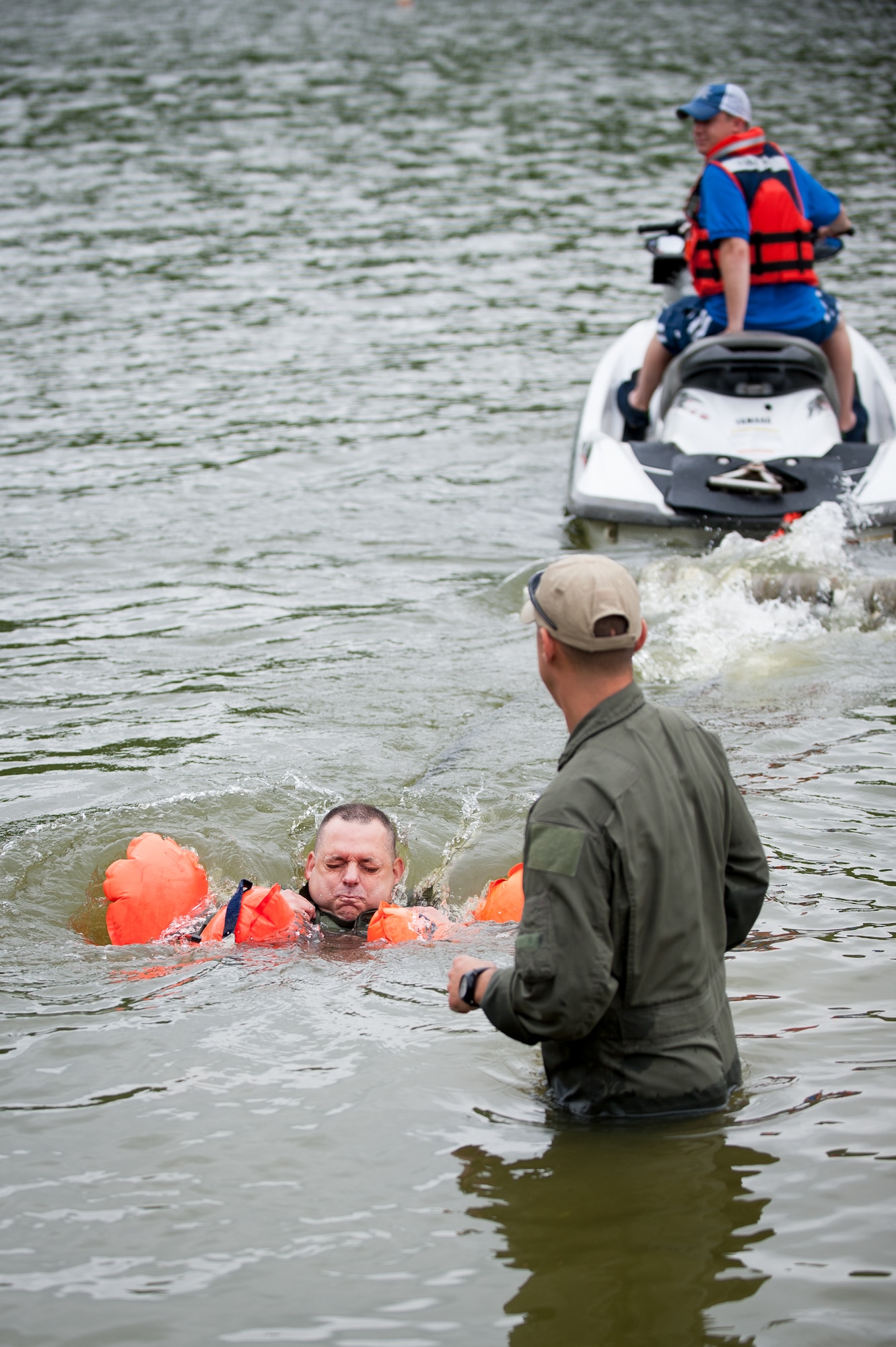 Maj. Todd Franks, a pilot in the Kentucky Air National Guard’s 165th Airlift Squadron, is pulled across Taylorsville Lake in Taylorsville, Ky., by a personal watercraft June 5, 2014, as part of routine survival training. The exercise is designed to simulate what could happen to aircrew members who’ve parachuted into water when the wind catches their open chutes and drags them across the surface, posing the risk of drowning. (U.S. Air National Guard photo by Maj. Dale Greer)