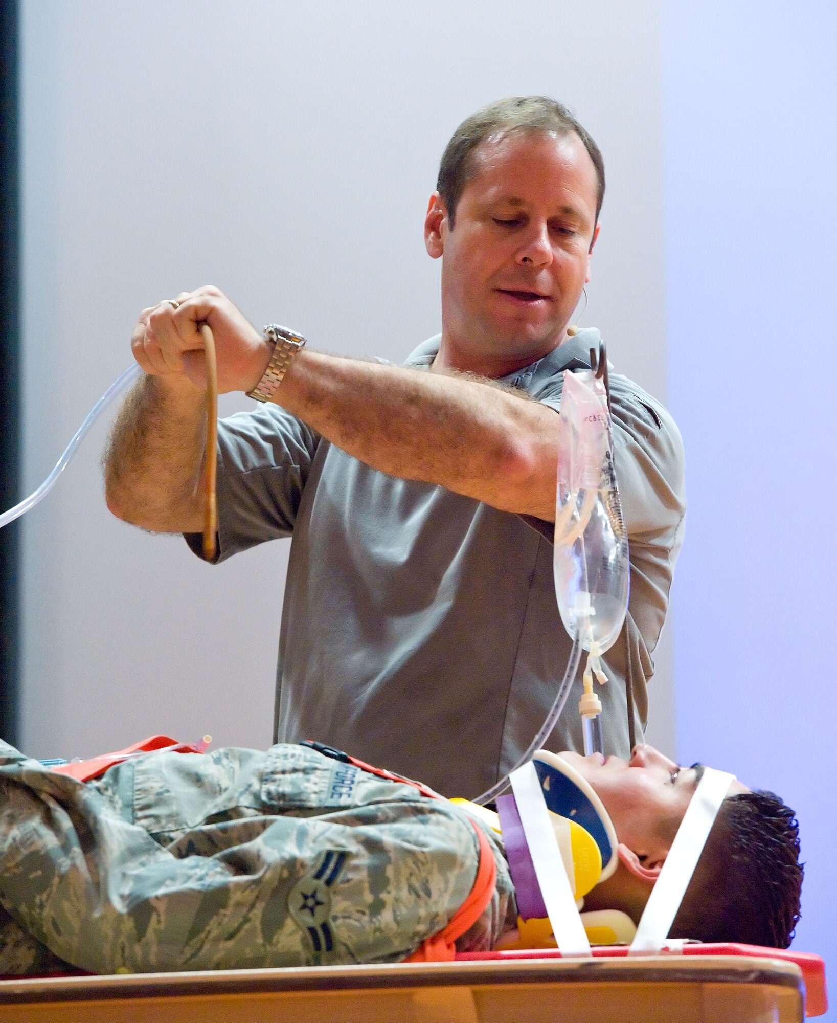 Ralph Jimenez, left, Street Smart program team member, talks to Airman 1st Class Jon Martinez, right, 436th Aerial Port Squadron cargo processor, June 27, 2014, at the Base Theater on Dover Air Force Base, Del. Jimenez explained to Martinez the process of removing a catheter two days after a simulated vehicle accident he was involved in resulting in traumatic injuries. (U.S. Air Force photo/Roland Balik)