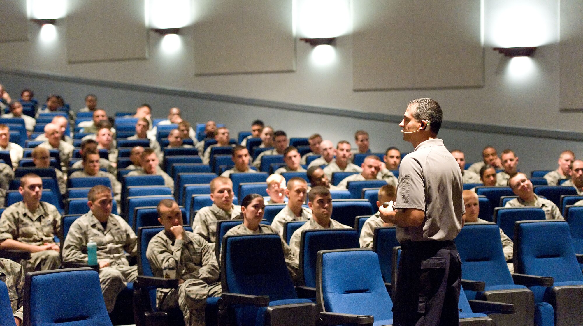 Oscar Duran, right, Street Smart program team member, talks to Team Dover members E-4 and below, and lieutenants, June 27, 2014, at the Base Theater on Dover Air Force Base, Del. Stay Alive from Education - S.A.F.E., Inc. provided the Street Smart mishap prevention program that covered distracted driving, driving under the influence and seatbelt use. In 2013 the Street Smart program was presented to over 30,000 Airman at 29 Air Force installations. (U.S. Air Force photo/Roland Balik)