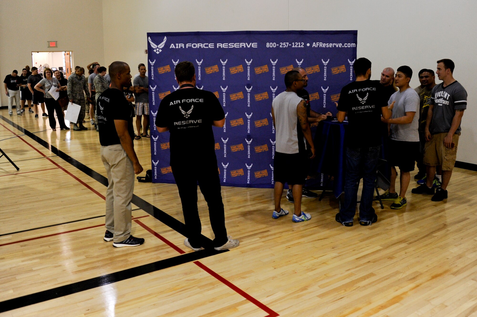 A line forms along the wall of the Risner Fitness Center during the Ultimate Fighting Championship Fit Tour fitness workshop June 25, 2014, at Joint Base McGuire-Dix-Lakehurst, N.J. The tour brought Carlos Condit, UFC fighter, and Mike Dolce, UFC Fit coach, as a tool, sponsored by the U.S. Air Force Reserve, to promote health and fitness throughout the military. (U.S. Air Force photo by Airmen 1st Class Tara A. Williamson/Released)