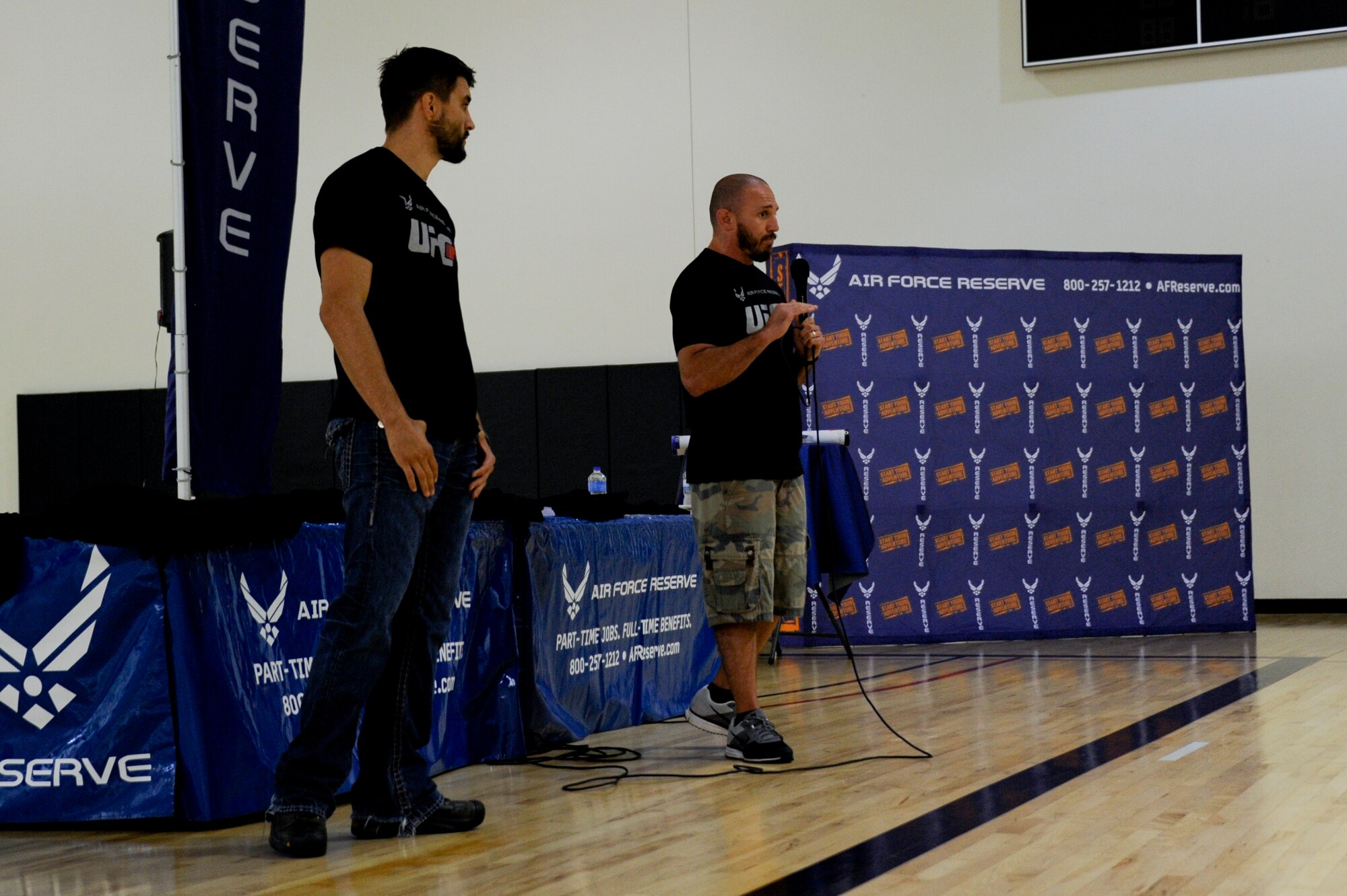 Mike Dolce, Ultimate Fighting Championship Fit coach, speaks to service members and their families about setting daily goals during the UFC Fit Tour fitness workshop June 25, 2014, at Joint Base McGuire-Dix-Lakehurst, N.J. The tour is a tool sponsored by the U.S. Air Force Reserve to promote health and fitness throughout the military. (U.S. Air Force photo by Airmen 1st Class Tara A. Williamson/Released)