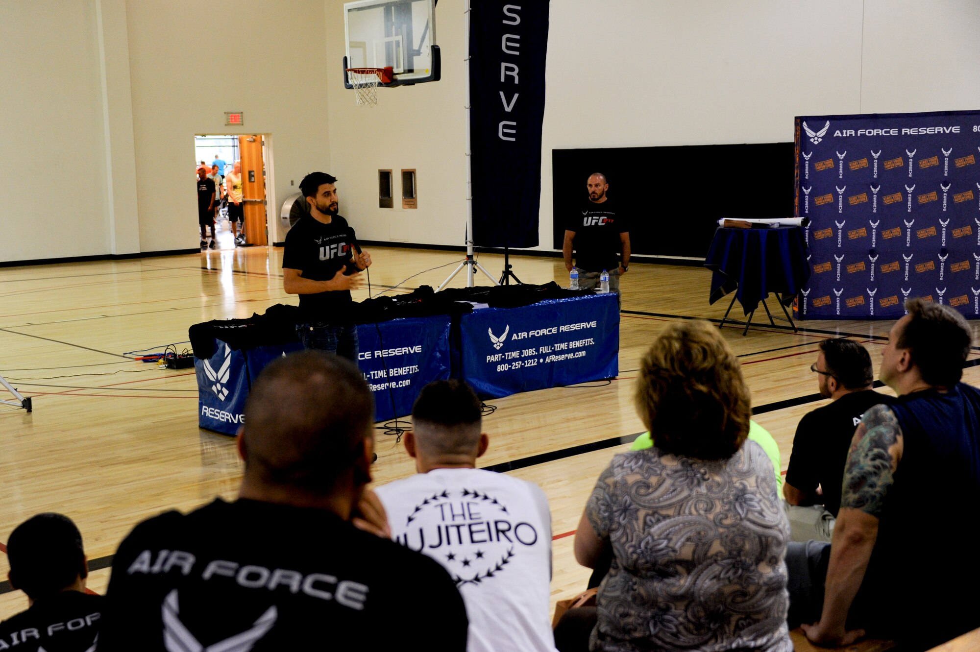 Carlos Condit, Ultimate Fighting Championship fighter, speaks to service members and their families about how he stays in shape during the UFC Fit Tour fitness workshop June 25, 2014, at Joint Base McGuire-Dix-Lakehurst, N.J. The tour is a tool sponsored by the U.S. Air Force Reserve to promote health and fitness throughout the military. (U.S. Air Force photo by Airmen 1st Class Tara A. Williamson/Released)