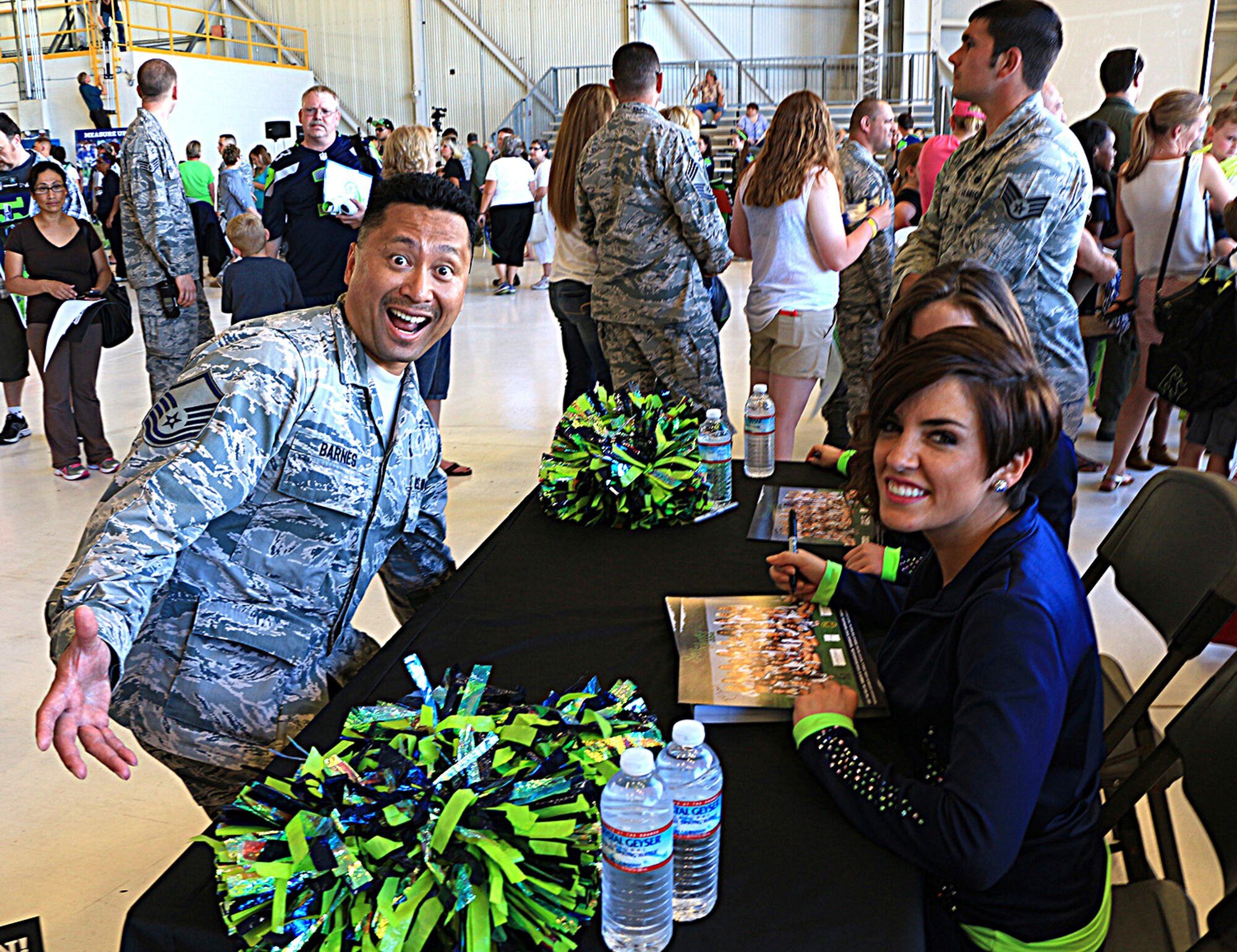 Master Sgt. John Barnes, 446th Aeromedical Staging Squadron, hams it up while getting autographs from the Sea Gals at the Heroes of 12 tour event July 1 at Joint Base Lewis-McChord, Washington. (U.S. Air Force Reserve photo by Senior Airman Madelyn McCullough)