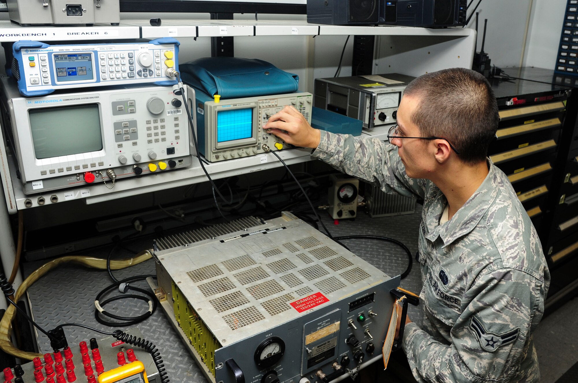 Airman 1st Class Zachary Setzer, a 19th Communications Squadron airfield systems apprentice, adjusts modulation percentages which allows audio to travel to other radios June 30, 2014, at Little Rock Air Force Base, Ark. Setzer, a Hope Mills, N.C., native, devoted 57 hours of his personal time to the Big Brothers/Big Sisters program. (U.S. Air Force photo by Senior Airman Kaylee Clark)
