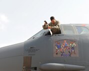Lt. Col. John Varilek, 2nd Operations Support Squadron commander, removes the previous commander's name from the 2nd OSS flagship during a change of command ceremony at Barksdale Air Force Base, La., July 2, 2014. After every flying unit change of command, the previous commander's name is removed from the squadron flagship aircraft and the new commander's name is revealed. Varilek is a senior evaluator pilot with more than 1,300 hours in the B-52H Stratofortress. (U.S. Air Force photo/Senior Airman Benjamin Gonsier)