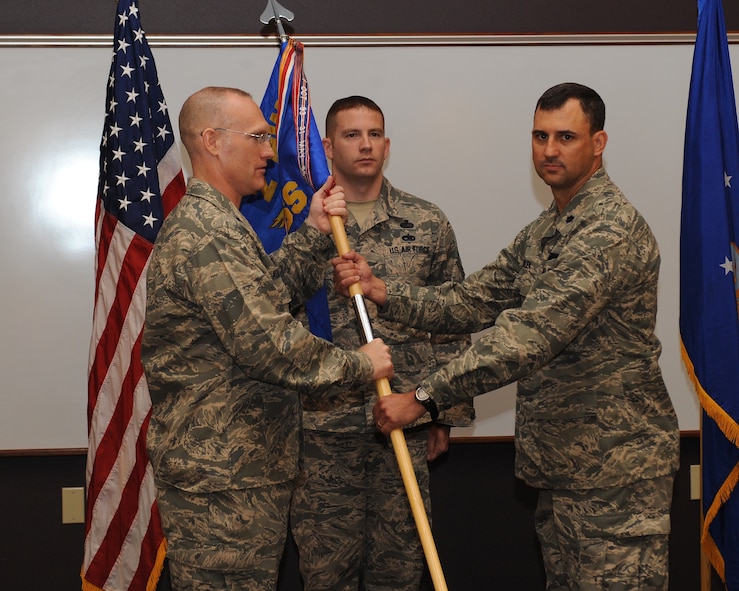 Lt. Col. John Varilek assumes command of the 2nd Operations Support Squadron from Col. Michael Adderley, 2nd Operations Group commander, during a change of command ceremony at Barksdale Air Force Base, La., July 2, 2014. Before taking command of the 2nd OSS, Varilek was the Director of Operations, 11th Bomb Squadron, from July 2013 to July 2014. (U.S. Air Force photo/Senior Airman Benjamin Gonsier)