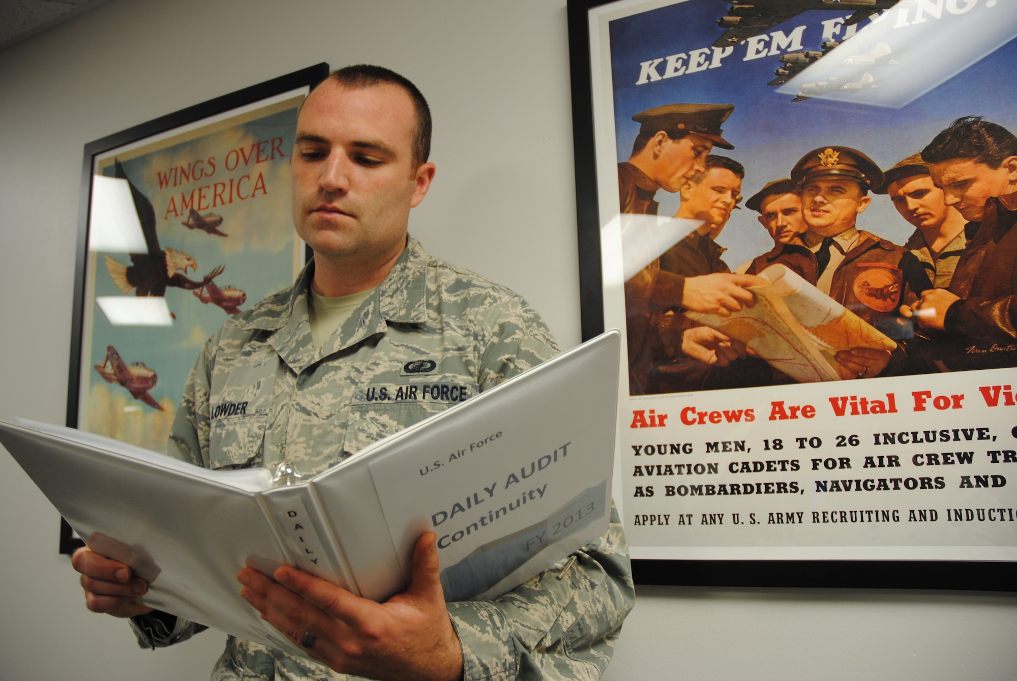 Senior Airman Jeffrey M. Lowder reviews his daily audit continuity binder on July 2, 2014, at his work station on Grand Forks Air Force Base, N.D. As a financial analysis supervisor for the 319th Comptroller Squadron, Lowder conducts daily audit of organizational accounts and approves submissions for the Defense Travel System. He completed the financial management course during technical training at Keesler Air Force Base, Miss. (U.S. Air Force photo/Staff Sgt. Luis Loza Gutierrez)
