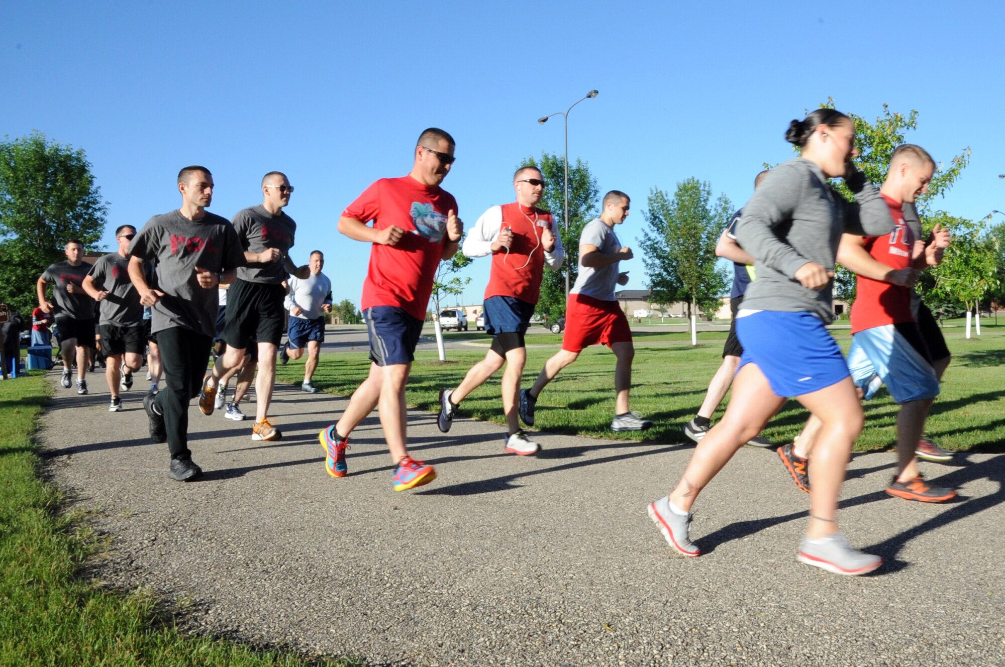 Runners take off at the start of the Independence 5K on Grand Forks Air Force Base, N.D., July 2, 2014. More than two dozen men, women and children turned out to participate. (U.S. Air Force photo/Staff Sgt. David Dobrydney)