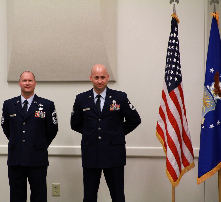 ROBINS AIR FORCE BASE, Ga. - Chief Master Sgt. Seth Perron, superintendent of Headquarters Readiness and Integration Organization, and Master Sgt. Jerrod Kester, first sergeant of HQ RIO, stand at parade rest during the Readiness Management Group Inactivation Ceremony here July 1. The RMG was created in April 2005 to centrally manage individual mobilization augumentees.  (US Air Force photo/Tech. Sgt. Tony Faulcon)