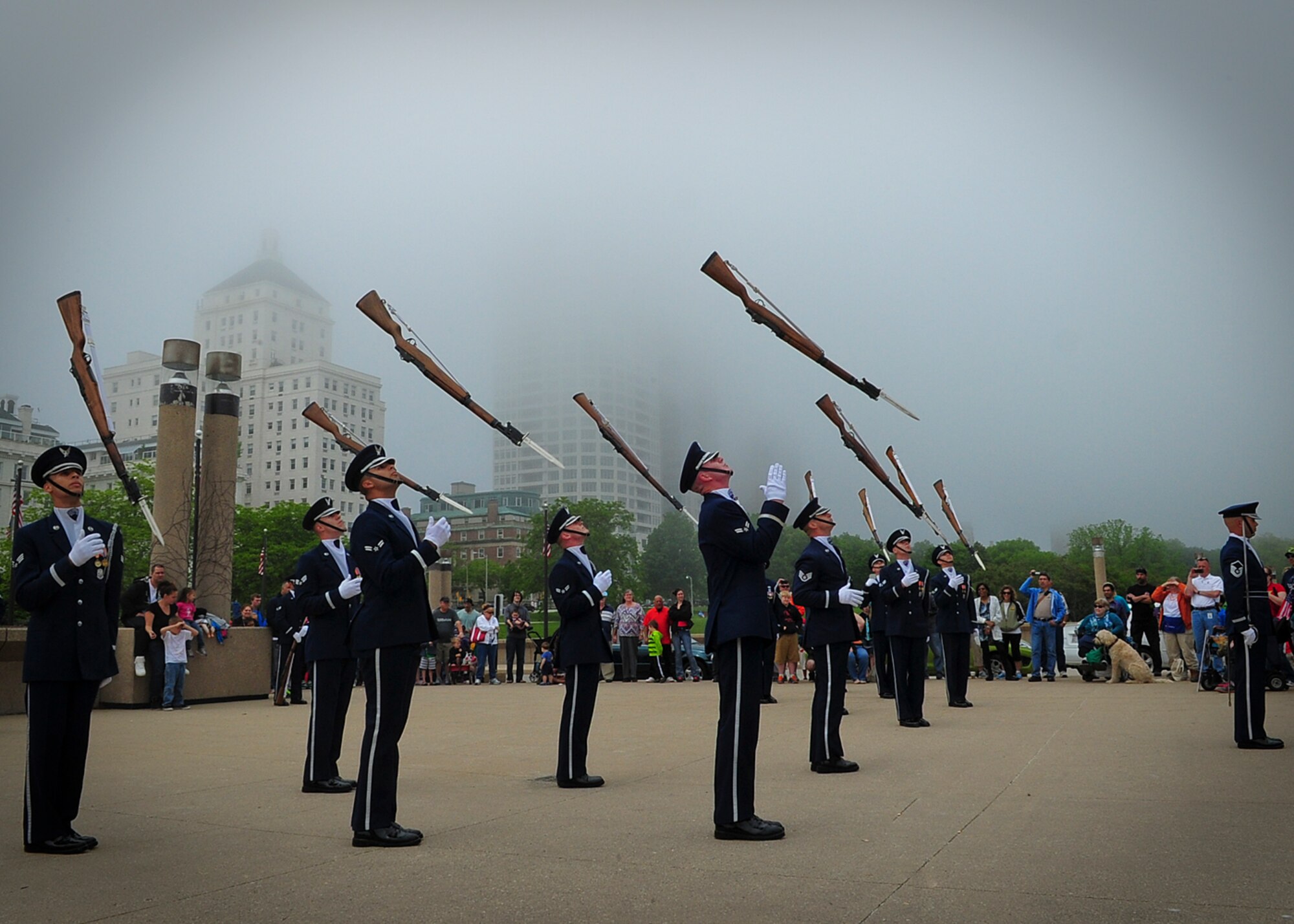 U.S. Air Force Honor Guard Drill Team members toss their rifles in the air during a performance at the Milwaukee Air and & Water Show June 21, 2014. Heavy fog prevented much of the air show from taking place and the Drill Team was one of the few groups to perform. The Drill Team recently completed a nine-day, seven-city, 10-performance tour across the Midwest with the U.S. Air Force Band’s rock ensemble Max Impact. During the tour, the two groups performed in Wisconsin, Minnesota, South Dakota, Wyoming and Nebraska. (U.S. Air Force Photo by 1st Lt. Nathan Wallin)