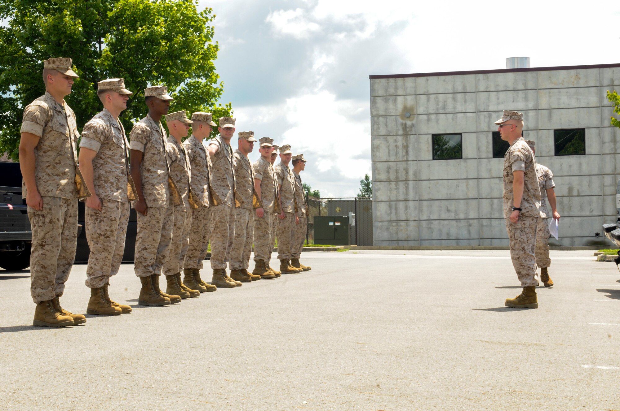 U.S. Marine Corps Sgt. Adam Frabott, with Detachment 3, Maintenance Company Logistics Battalion 453, instructs fellow Marines in marching techniques here, June 26, 2014. The Marines were here for a drill weekend. U.S. Air Force photo/Eric M. White.