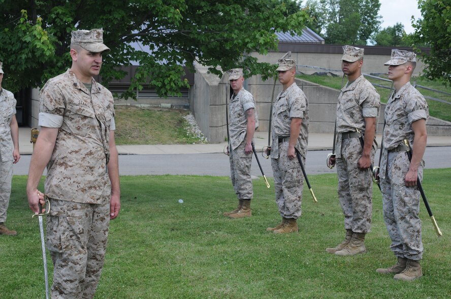 U.S. Marine Corps Reserve Sgt. Gregory Stanek, a Reserve staff section leader with Detachment 3, Maintenance Company Logistics Battalion 453, demonstrates maneuvers with a Marine Corps’ drill and ceremonial sword for a group of a Youngstown Marine Corps Reservists stationed here, June 26, 2014. The non-commissioned officer sword tradition dates back to 1859. The Marines were here for a drill weekend. U.S. Air Force photo/Eric M. White.