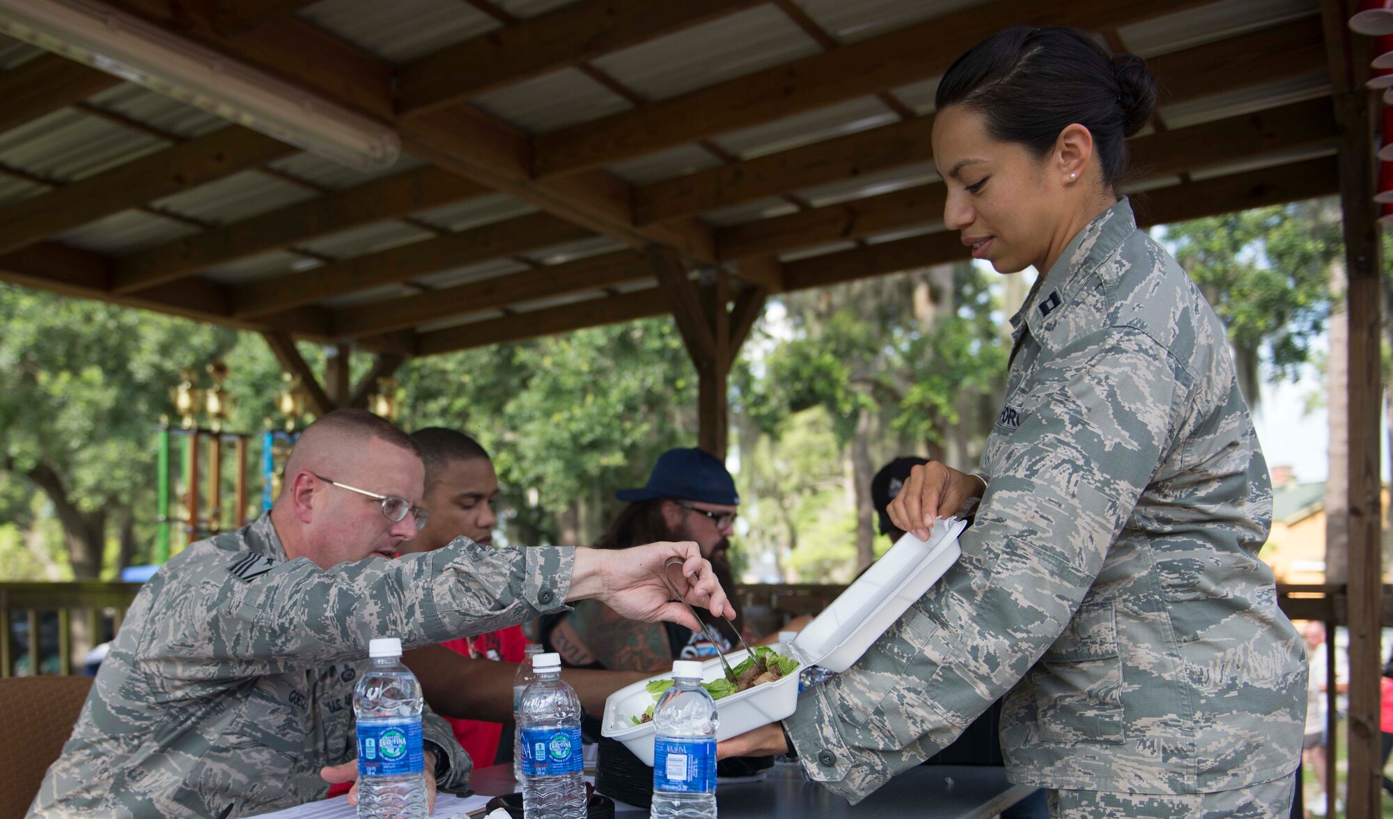 U.S. Air Force Chief Master Sgt. Michael Goetz, left, 93d Air Ground Operations Wing command chief, and Capt. Melissa Garcia, 23d Force Support Squadron sustainment services flight commander, taste test for the best in show category during the Moody Field Club’s Barbecue Cook-off June 27, 2014, at Moody Air Force Base, Ga. Team AGOW Style won the cook-off in the best in beef category for their brisket. (U.S. Air Force photo by Airman Dillian Bamman/Released)