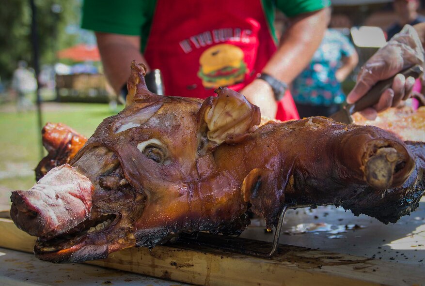 Team First Sergeants prepare a cooked pig for consumption during the Moody Field Club’s Barbecue Cook-off June 27, 2014, at Moody Air Force Base, Ga. The team cooked the pig in a charcoal pit for four hours before serving it to attendees. (U.S. Air Force photo by Airman Dillian Bamman/Released)