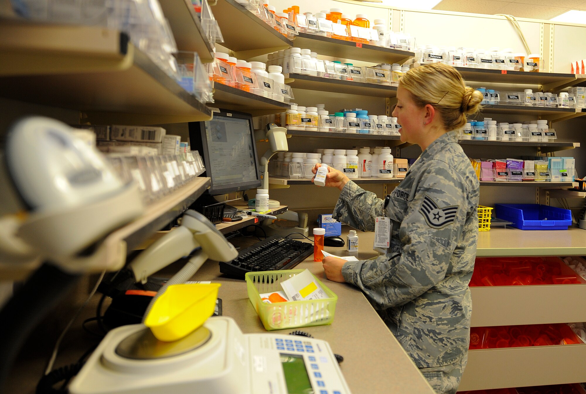 Staff Sgt. Tracy Duncan, 1st Special Operations Medical Operations Squadron narcotics vault custodian, scans medication at the pharmacy on Hurlburt Field, Fla., May 30, 2014. Once pills are sealed in containers, they are scanned, labeled and sorted for customer use. (U.S. Air Force photo/Airman 1st Class Andrea Posey)