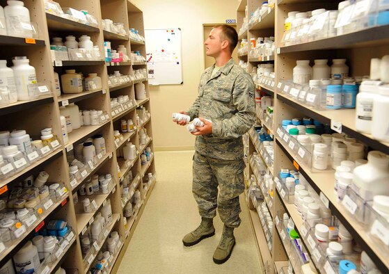 Airman 1st Class Christopher Mauldin, 1st Special Operations Medical Operations Squadron medical logistics technician, stores medication at Hurlburt Field, Fla., May 30, 2014. Medication is alphabetically stored on selves until a prescription needs to be filled. (U.S. Air Force photo/Airman 1st Class Andrea Posey)