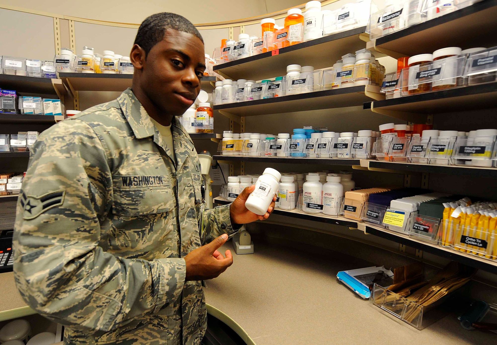 Airman 1st Class Donovan Washington, 1st Special Operations Medical Operations Squadron pharmacy technician, sorts pill bottles at Hurlburt Field, Fla., May 30, 2014. The unit promotes and maintains 8,900 active-duty members’ health. (U.S. Air Force photo/Airman 1st Class Andrea Posey)
